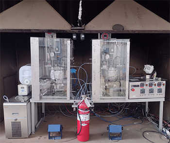 two Bench Environmentally-friendly fuel Lubricant Test (BELT) rig a large hood with the Hydrogen BELT rig (left) and the ammonia BELT rig (right)