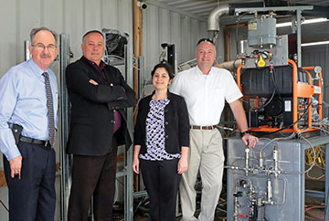 Authors standing next to equipment 