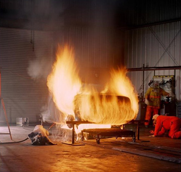 A fully charged electric vehicle battery engulfed in flames.