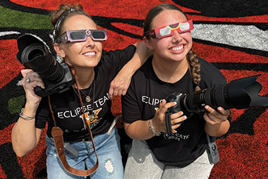 Two Kemp high school students viewing eclipse from the football field.