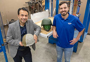 SwRI’s Dr. Daniel Portillo (right) and UTSA’s Dr. Morteza Seidi (left) holding examples of military helmet pads.