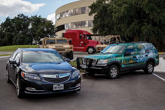 Photo of five different vehicles on SwRI campus.