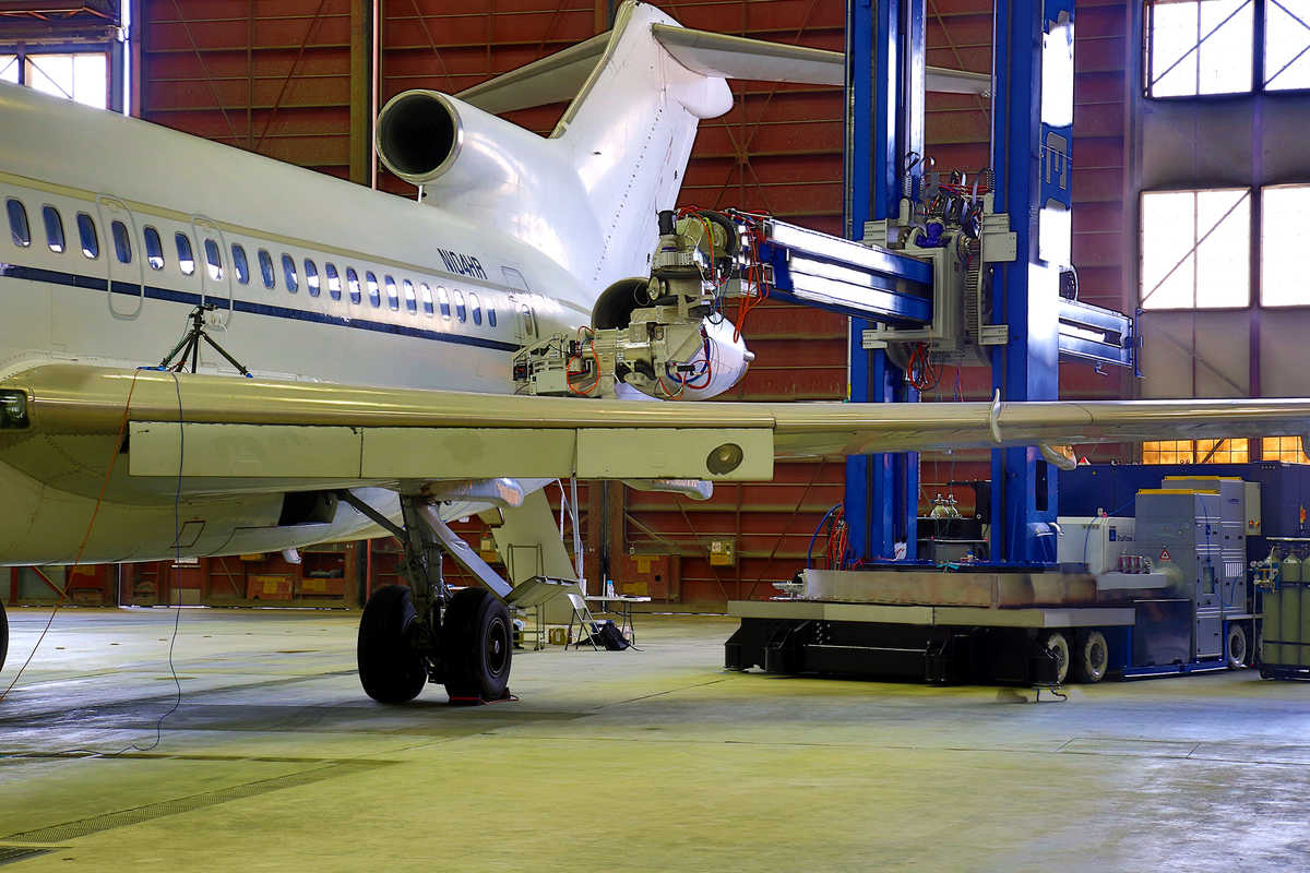 Laser coating removal robot at work on a full-body aircraft in a lab