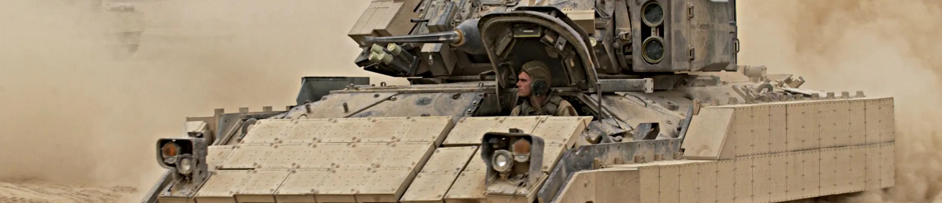 Bradley tank in motion across sand