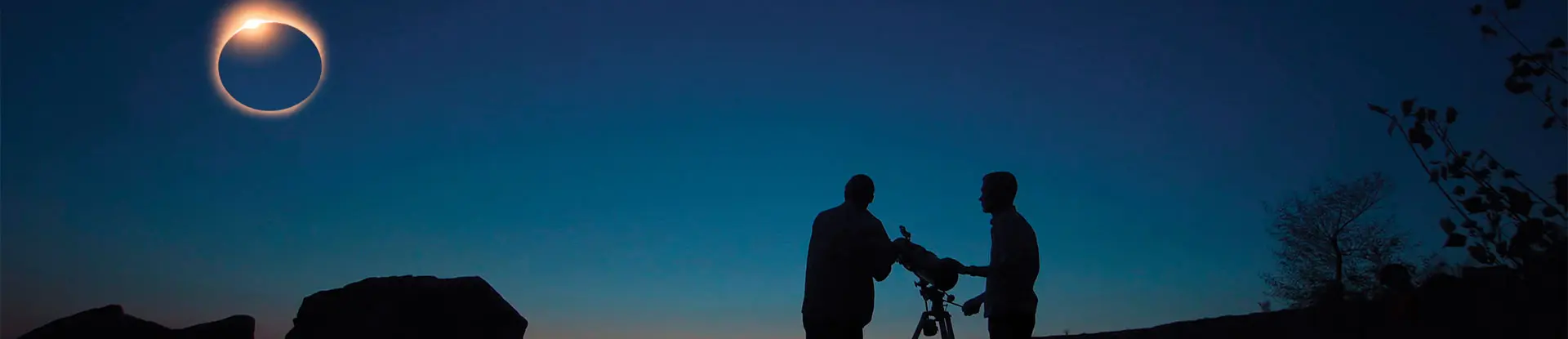 Two men with telescope watching eclipse