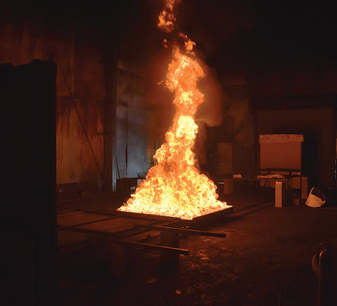 To verify resistance to fire and explosion, fire specialists expose fully charged electric vehicle batteries to gasoline pool fires to assure they meet safety standards.