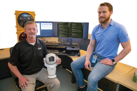 Portrait of Darin Parish and Dan Rossiter seated in front of a computer