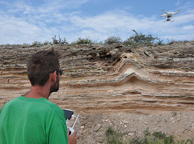 A drone flying over varied terrain