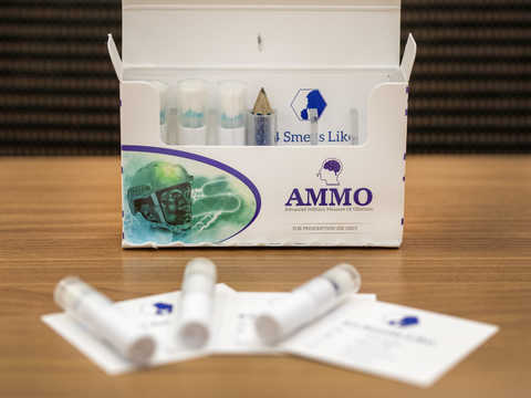 Open box of the AMMO test kit with contents laid out on a table