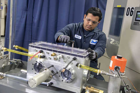 Engineer working on a battery immersion cooling test rig