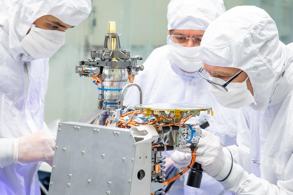 Three scientist using MASPEX instrument in clean room