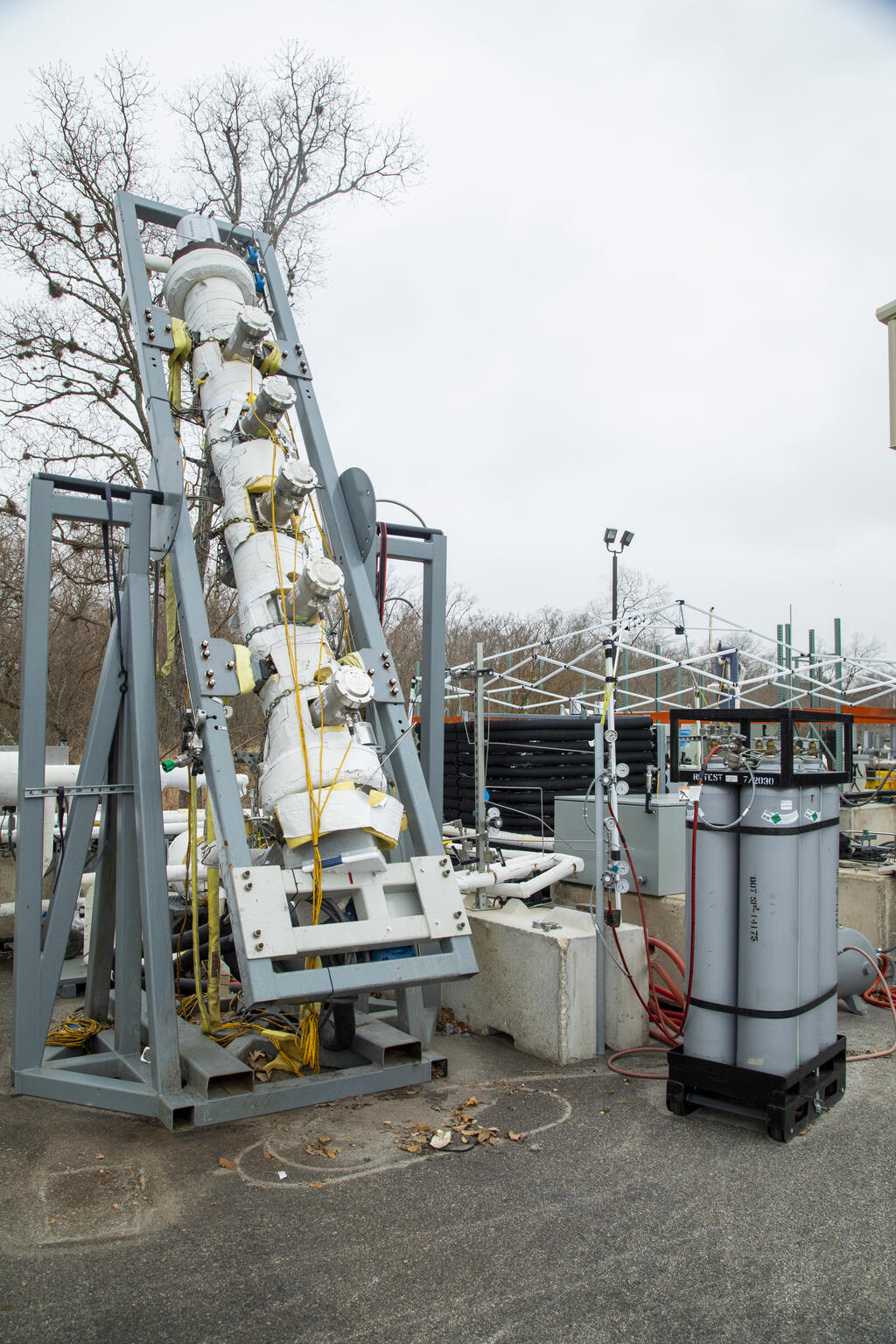 A metal gas foam test stand set up outdoors for testing